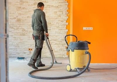 Man Vacuuming a Construction Site